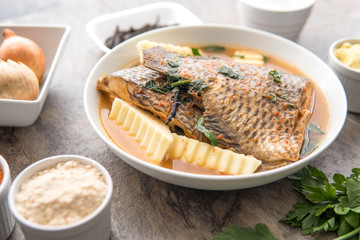 Grilled fish curry with plantain and salad. African national dish. Nigerian fish curry. Healthy lifestyle meal. Vegetarian food