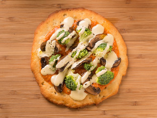 Raw Foods Pizza with broccoli, mushrooms, and cashew cheese