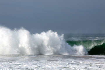 Sea waves crashing against clear sky