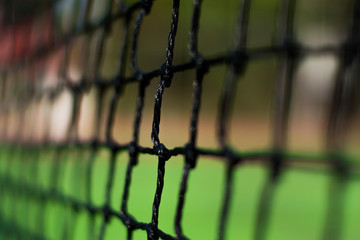 Tennis nets in the daytime.