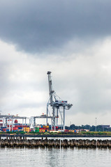 View of the cranes and shipping containers at Port Phillips, Princess pier, Melbourne, Australia.
