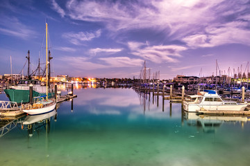 Fototapeta na wymiar Sailboats moored on a peaceful bay at night, long exposure, Australia.