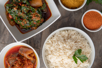 African national food dish grilled meat and chicken dish wings home-made Cuisine with plantain with jollof rice. Nigerian Jolofrice. Grilled African fish dish and meal with chilli banana and plantain.