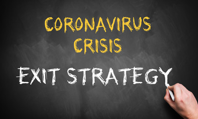 Fototapeta premium hand writing the message CORONAVIRUS CRISIS - EXIT STRATEGY on a blackboard