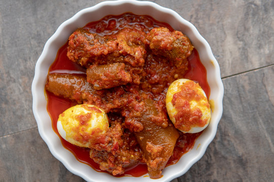 African national food dish grilled meat and chicken dish wings home-made Cuisine with plantain with jollof rice. Nigerian Jolofrice. Grilled African fish dish and meal with chilli banana and plantain.