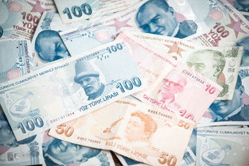 Many hundred Turkish lira on wooden table background texture. bundles of money scattered on the office desk. wealth and income concept. Counting money. 