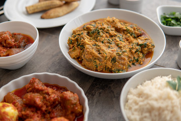 African national food dish grilled meat and chicken dish wings home-made Cuisine with plantain with jollof rice. Nigerian Jolofrice. Grilled African fish dish and meal with chilli banana and plantain.