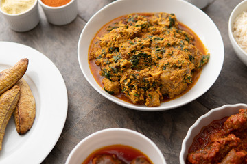 African national food dish grilled meat and chicken dish wings home-made Cuisine with plantain with jollof rice. Nigerian Jolofrice. Grilled African fish dish and meal with chilli banana and plantain. © Rahim