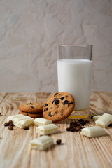 milk and cookies on wooden table