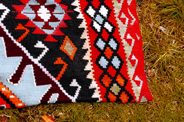 handmade carpet spread out on the street. color patterns. textile