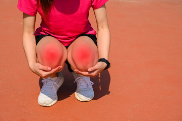 Cropped shot of woman runner kneel down, suffering from knee pain. It often happens when your...