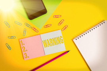 Writing note showing Warning. Business concept for Advice Sign for possible danger Safety symbol Caution alert Square blank sticky notepads pencil smartphone sheet color background