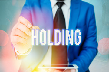 Word writing text Holding. Business photo showcasing stocks property and other financial assets in someone s is possession