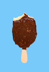 chocolate outer popsicle with couple of bites on blue background