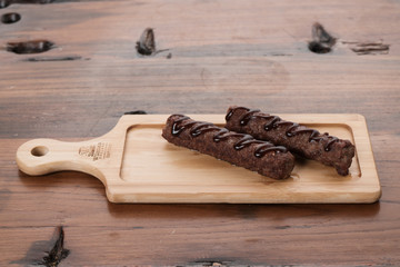 Grilled sausages on wooden board