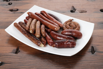 Grilled sausages on wooden board