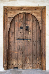 Old arched wooden door with an iron lock and bolt. Holy Cross Monastery In Omodos. Cyprus.