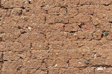 Background of brick wall covered with clay