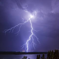 Bright flash of lightning in a stormy night sky