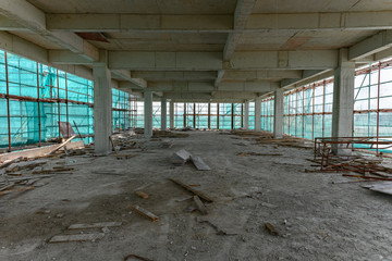 inside of an unfinished building with protection scaffolding and netting surrounded