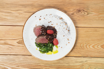 Obraz na płótnie Canvas meat dish on a plate with a side dish
