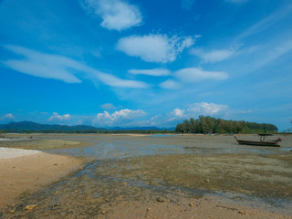 fishing boat on the low tide coast