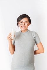 Asian girl smiles when she was drinking milk.Focus on face