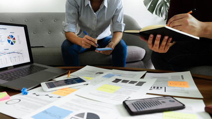 Business people writing on sticky notes for colleagues thinking strategy business plan or over problem in coworking office, Diverse Brainstorm Business Meeting Concept.