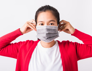 Closeup of portrait Asian adult woman wearing red shirt and face mask protective against...