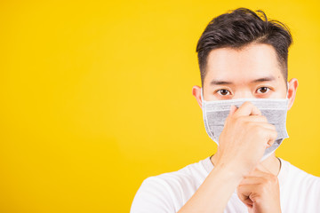 Portrait Asian handsome young man wearing face mask protective against coronavirus or COVID-19...