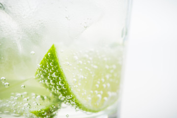 Rum based cocktail caipirinha (variation of cuba libre) on the white background. Selective focus....