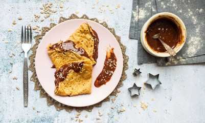 Folded crepes thin pancakes with chocolate sweet spread syrup.