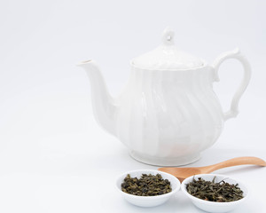 cup with tea and teapot on white background, over light
