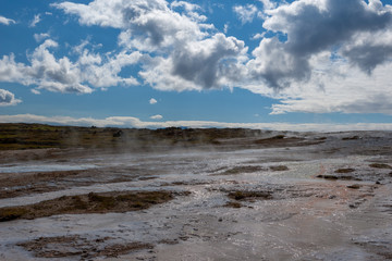 Beautiful colourful Icelandic landscape lava fields mountain geysers zigzag road and moss-covered stones Namafjall, Iceland.