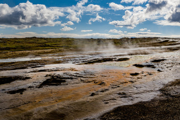 Beautiful colourful Icelandic landscape lava fields mountain geysers zigzag road and moss-covered...