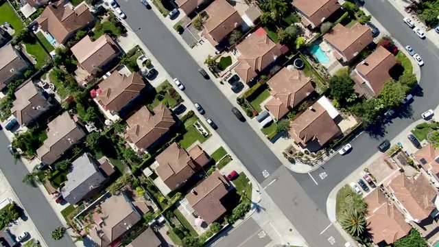 Aerial view of upper middle class neighborhood with residential subdivision mansion and swimming pool during with blue sky in San Diego, California, USA.