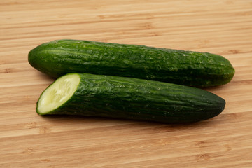 Green cucumber on a wooden background