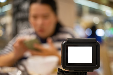 Action cam recording video of woman who looking at cell phone, Action cam monitor with copy space