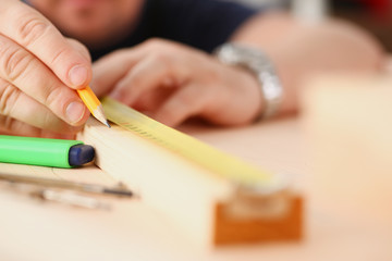 Arms of worker measuring wooden bar portrait. Manual job DIY inspiration improvement job fix shop yellow helmet joinery startup workplace idea hard hat career ruler industrial education