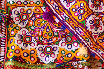 Fototapeta na wymiar Mirrored embroidery work typical of the Aahir tribe in Gujarat,india,Rajeshthan India embroidery close up view,handwork embroidery,selective focus on handmade embroidery. Traditional Indian handmade e