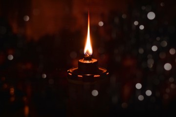 Oil lamp for Selamat Hari Raya greeting of muslim's new year with Bokeh effect. Image with low light view.