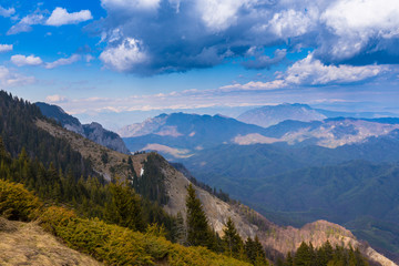 Spring mountain scenery in the Alps, wih snow covered ridges and clouds
