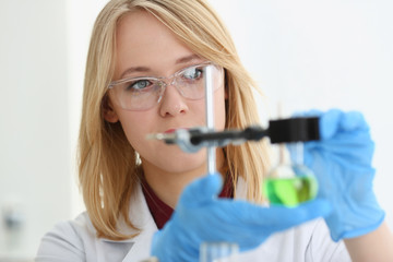 Technician hold in arms in protective gloves sample bottle with poison fluid portrait. Medical...