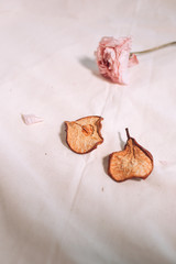 Dry pears and dry flower on white canvas, beautiful and tender