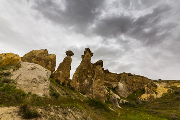 Beautiful sandstone rock formations in Cappadocia, Turkey, under stormy, cloudy, sky