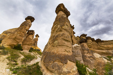 Fototapeta premium Beautiful sandstone rock formations in Cappadocia, Turkey, under stormy, cloudy, sky