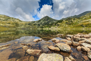 Summer scenery and glacier landscape in the Alps, with beautiful cumulus clouds