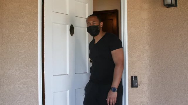 Black Man Leaving House In A Face Mask