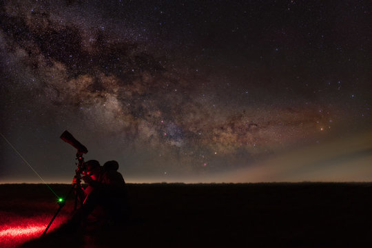Silhouette Of Man Star Gazing At Night