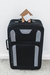Fototapeta na wymiar isolation and travel restrictions against the covid-19 virus outbreak, suitcase with Stay Home message and house icon